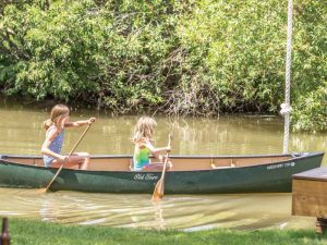 girls in canoe on a lake