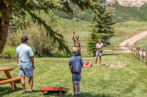family playing sack toss